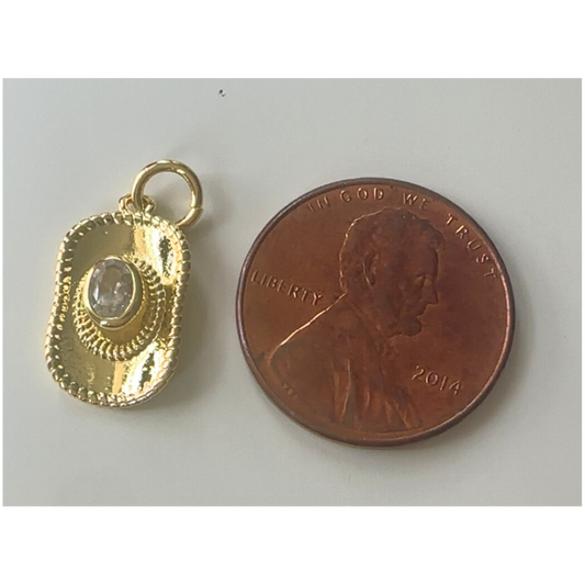 gold cowgirl hat charm next to penny