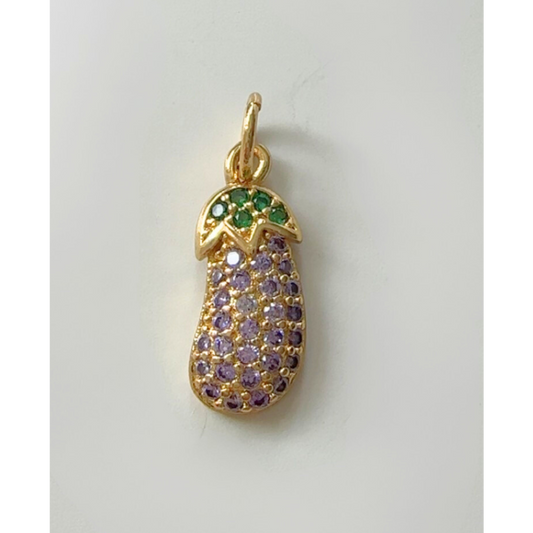 Gold eggplant pendant with green and purple gemstones on a light gray background