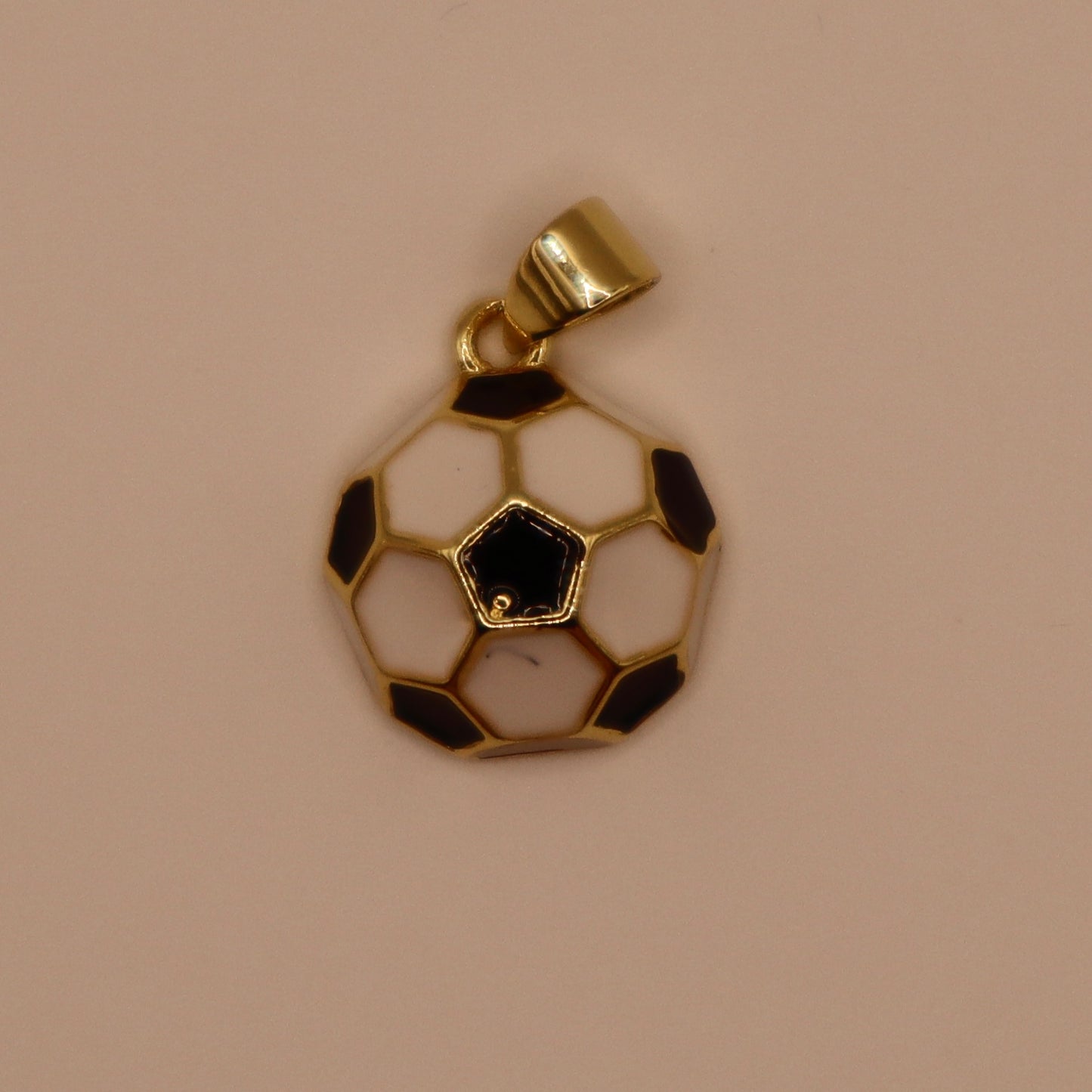 gold charm with black and white soccer ball 