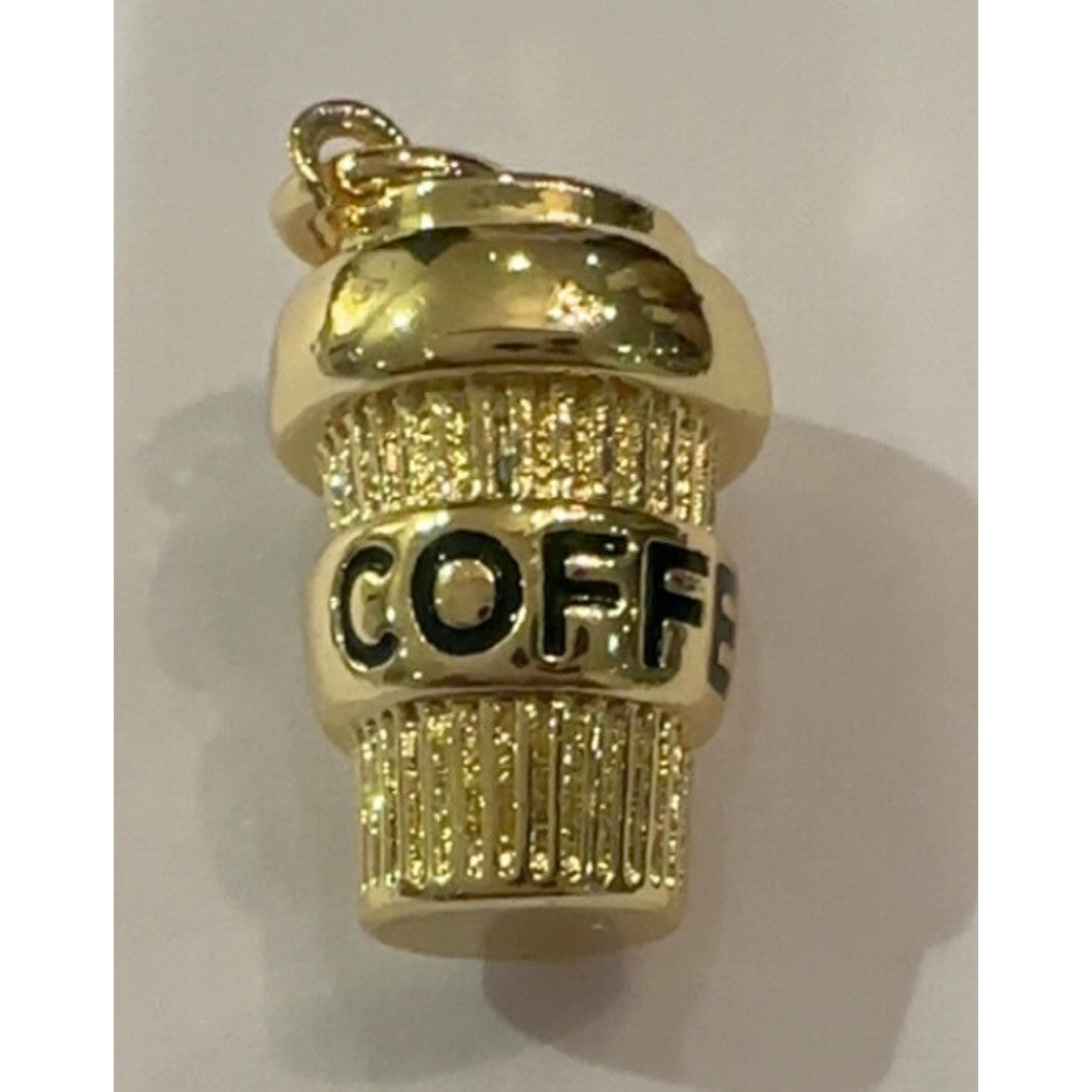 Gold coffee cup charm with 'COFFEE' text on a white background