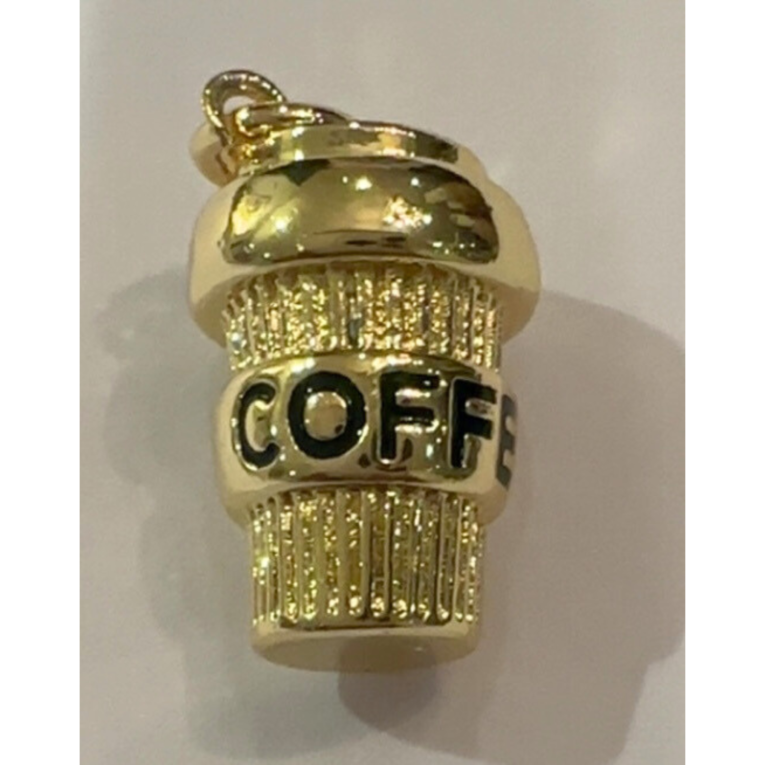 Gold coffee cup charm with 'COFFEE' text on a white background