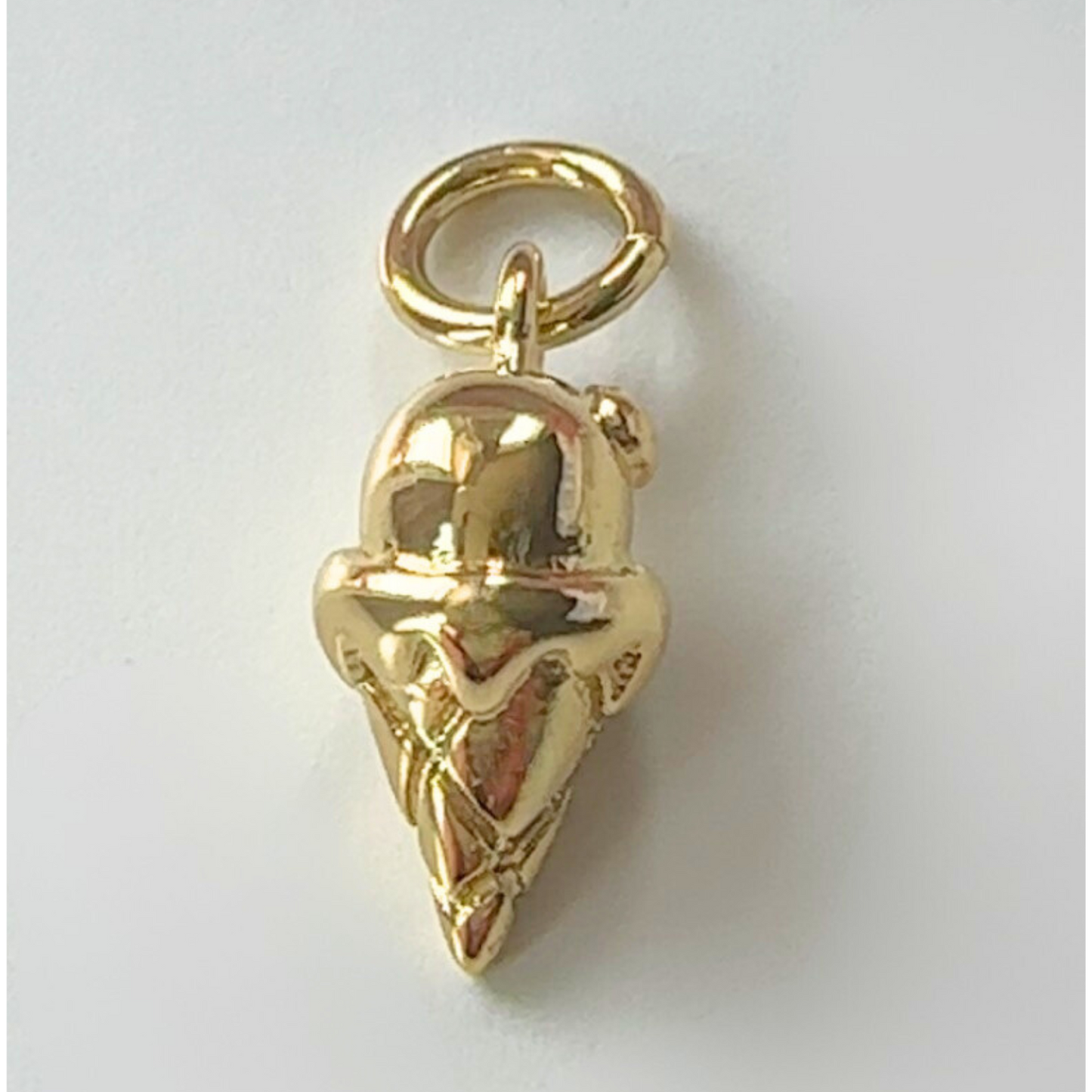 Gold ice cream charm on a white background