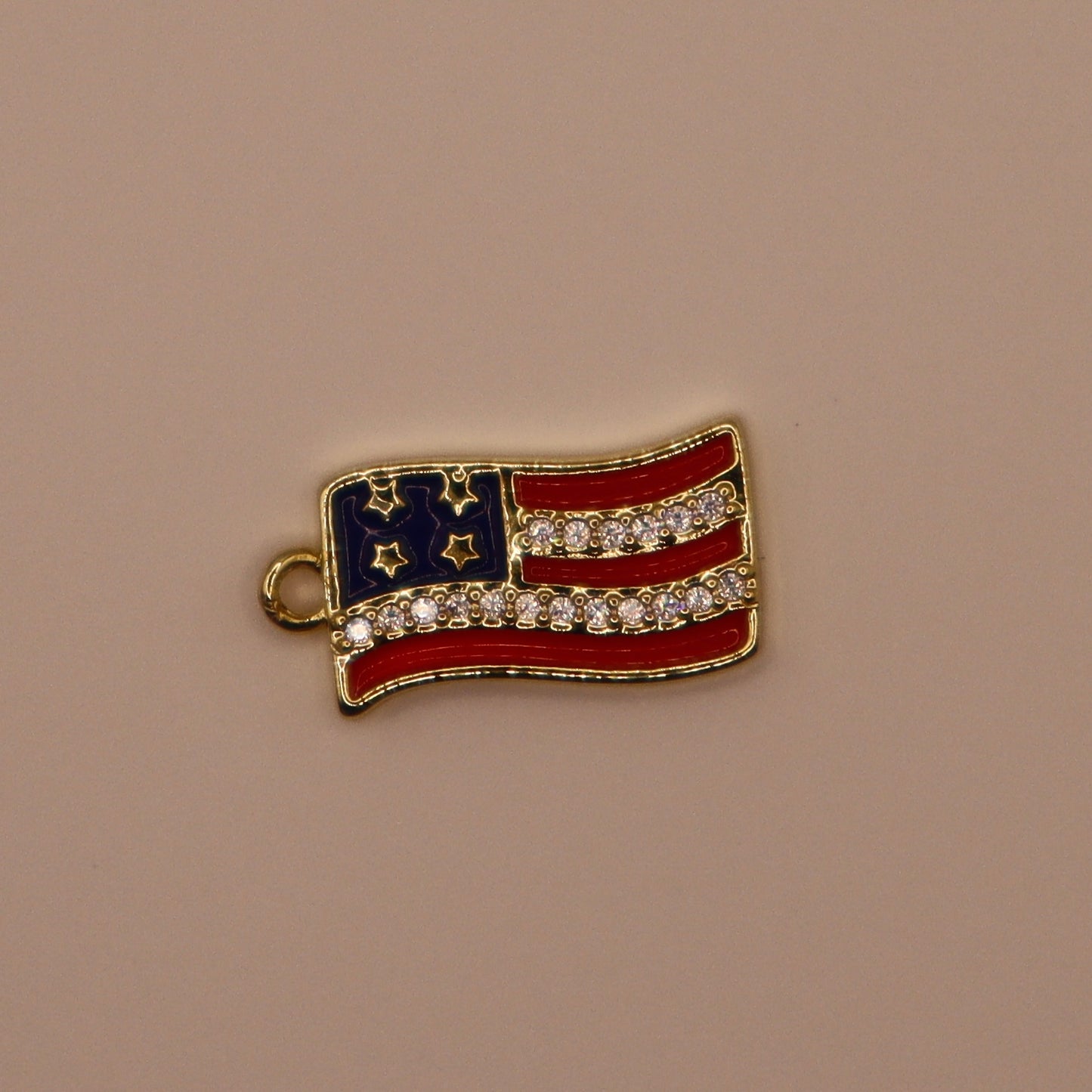 American flag charm with rhinestones on a beige background