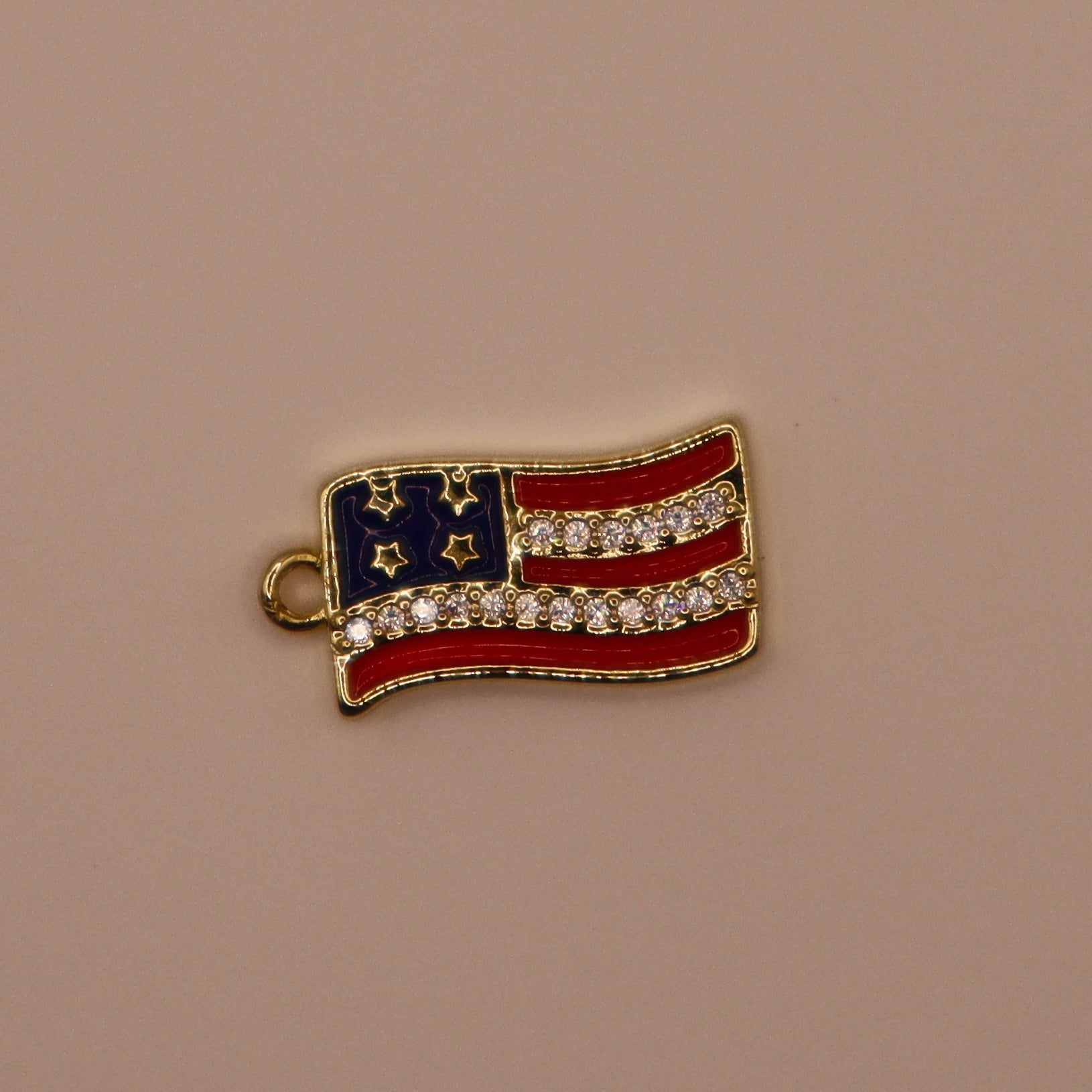 American flag charm with rhinestones on a beige background