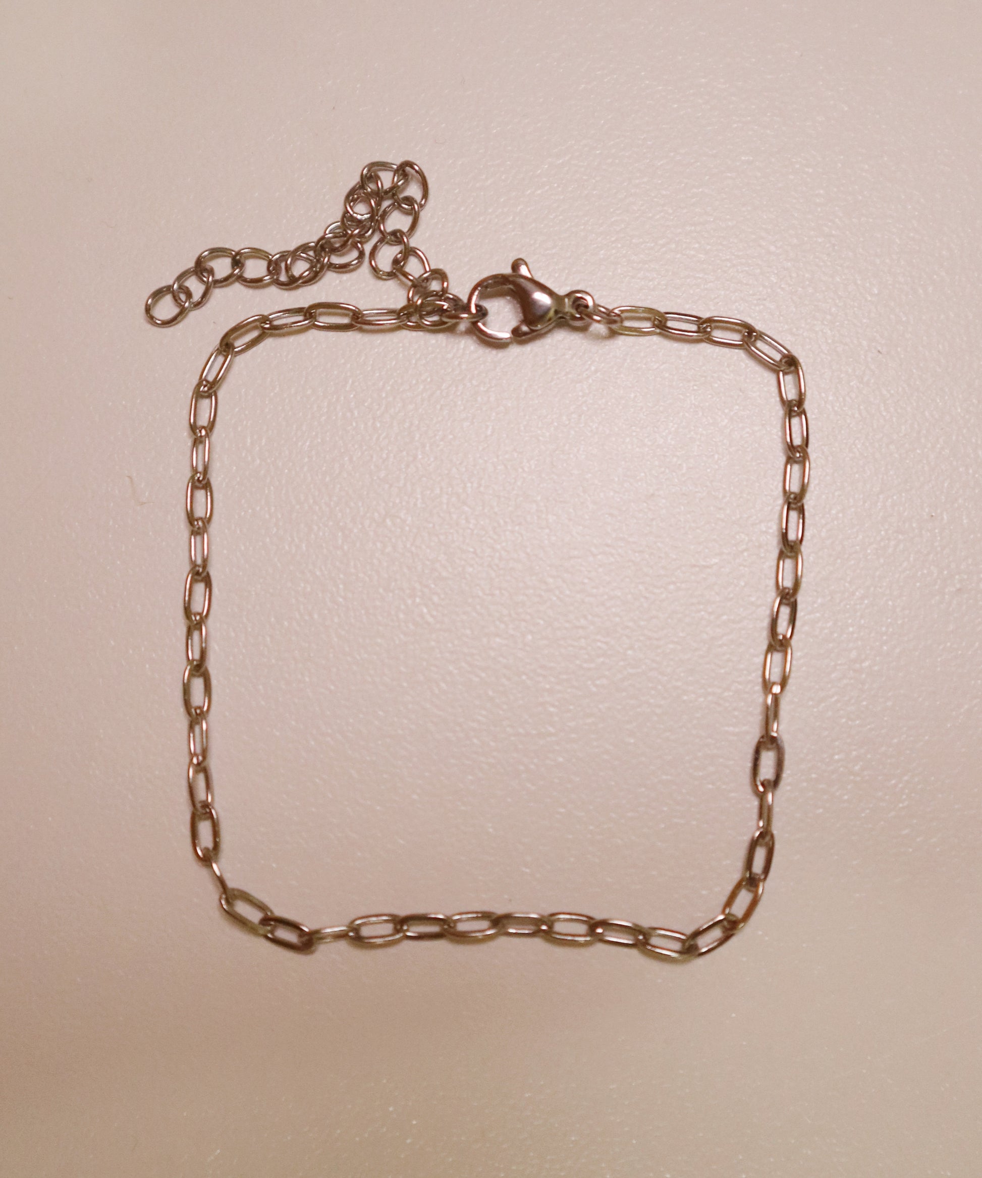 silver dainty  bracelet on a beige background
