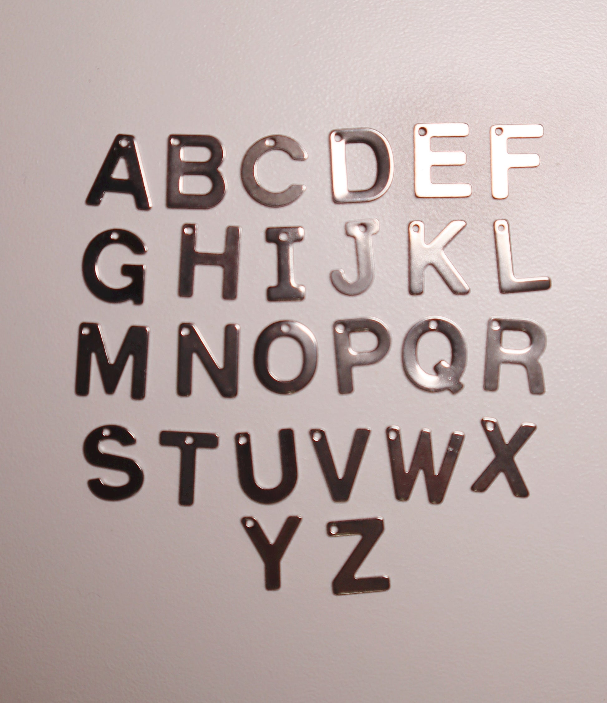 silver alphabet letters on a gray background