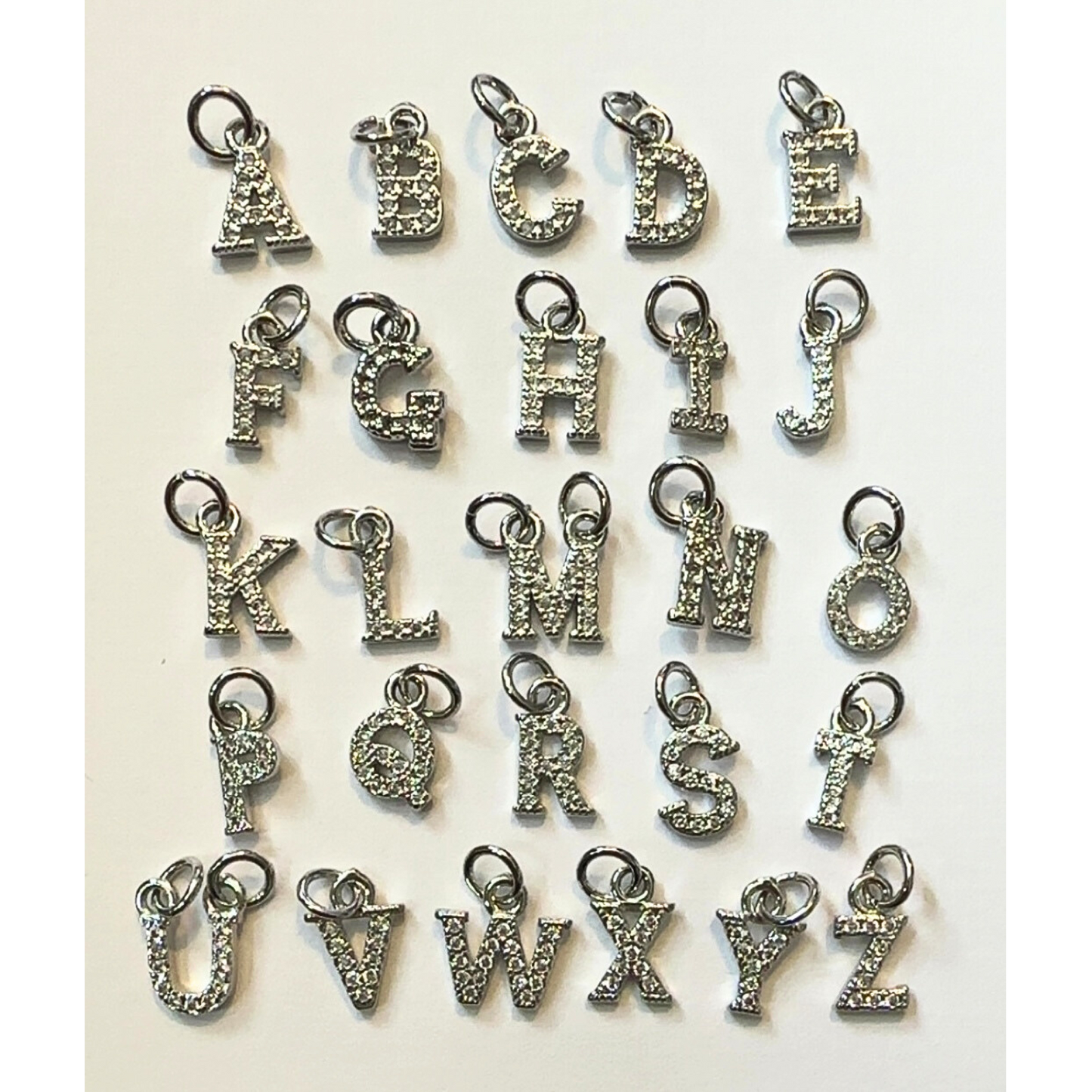 close up of silver rhinestone letter charms