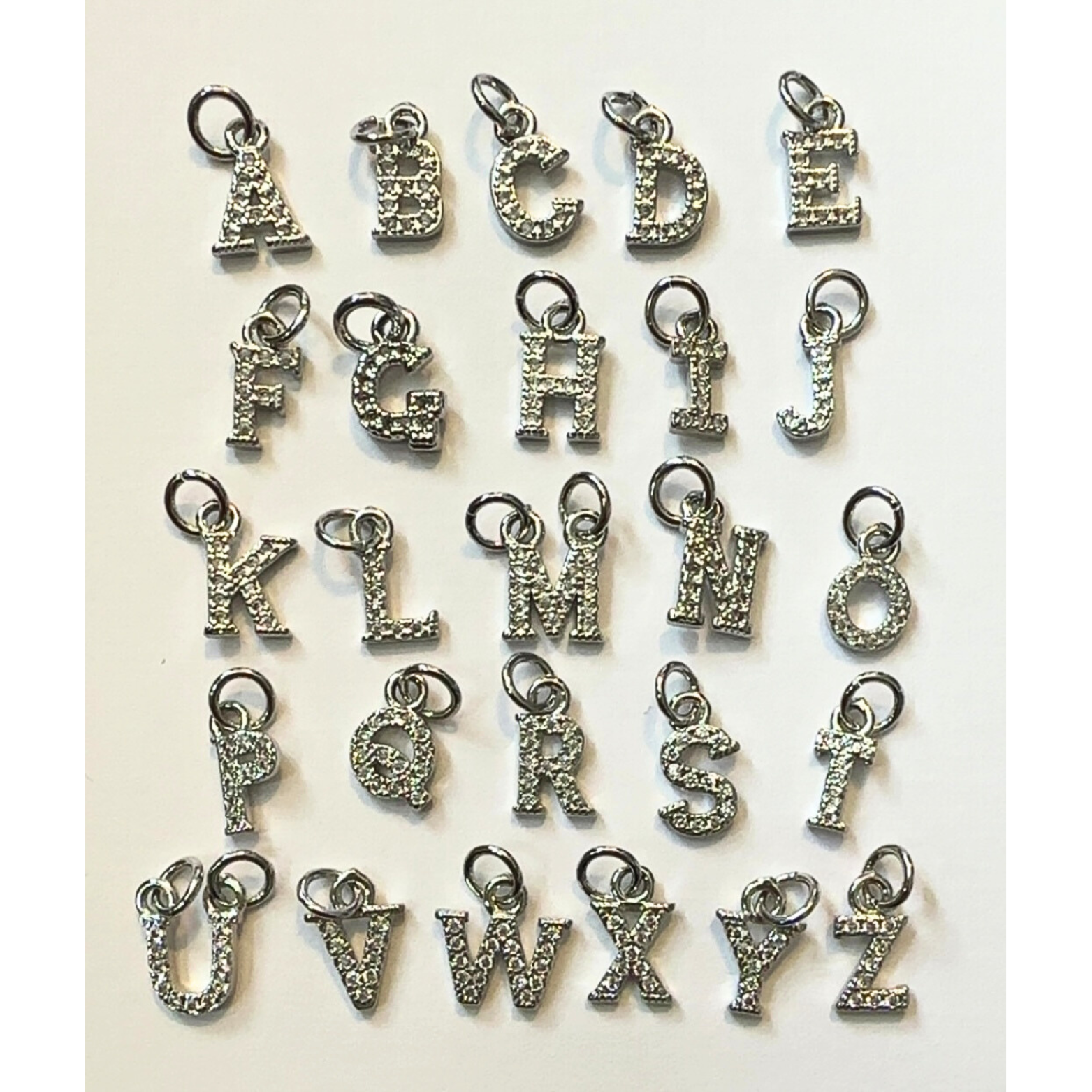 close up of silver rhinestone letter charms