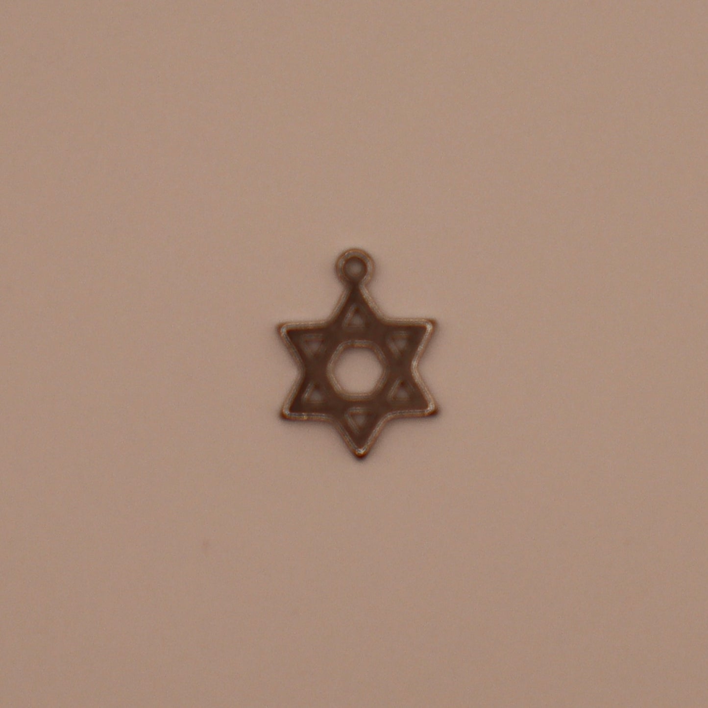 Star of David charm on a beige background