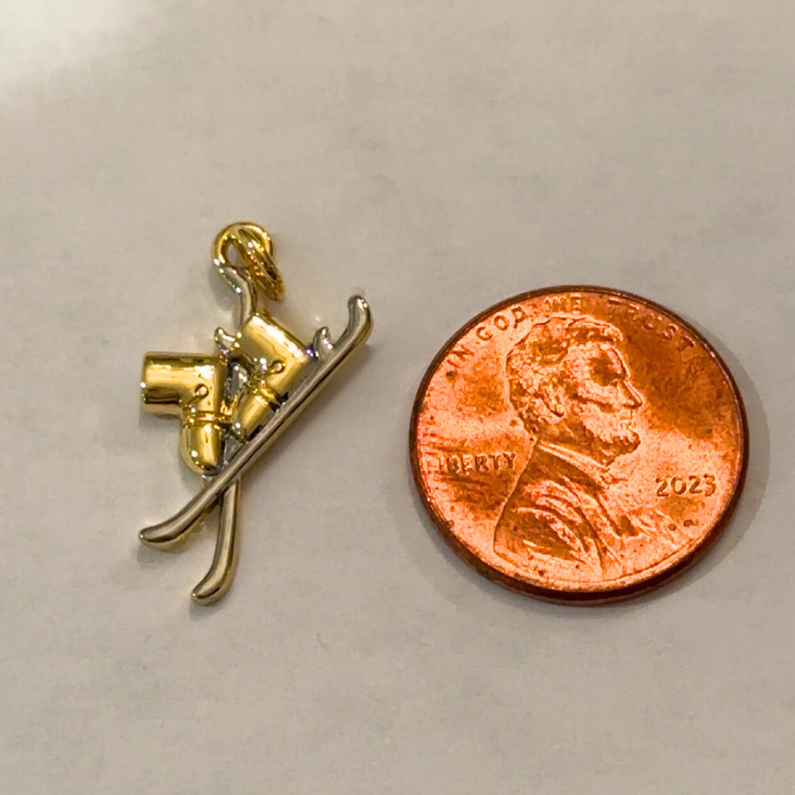 ski boot charm two toned next to penny
